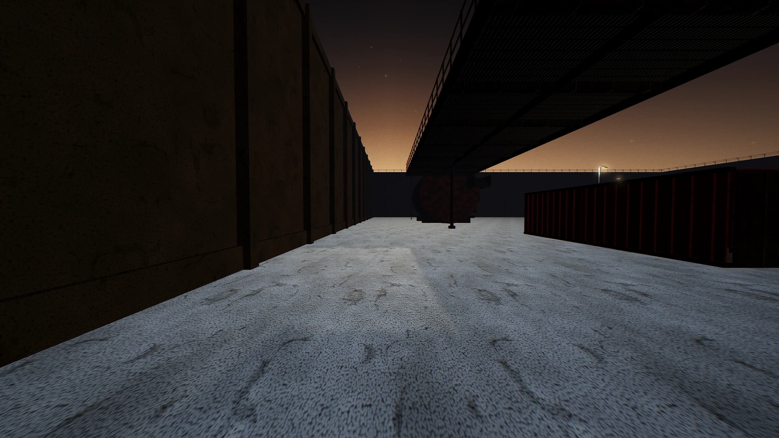 The east lane, running between the storage tanks and the perimeter with the gantry deck overhead.